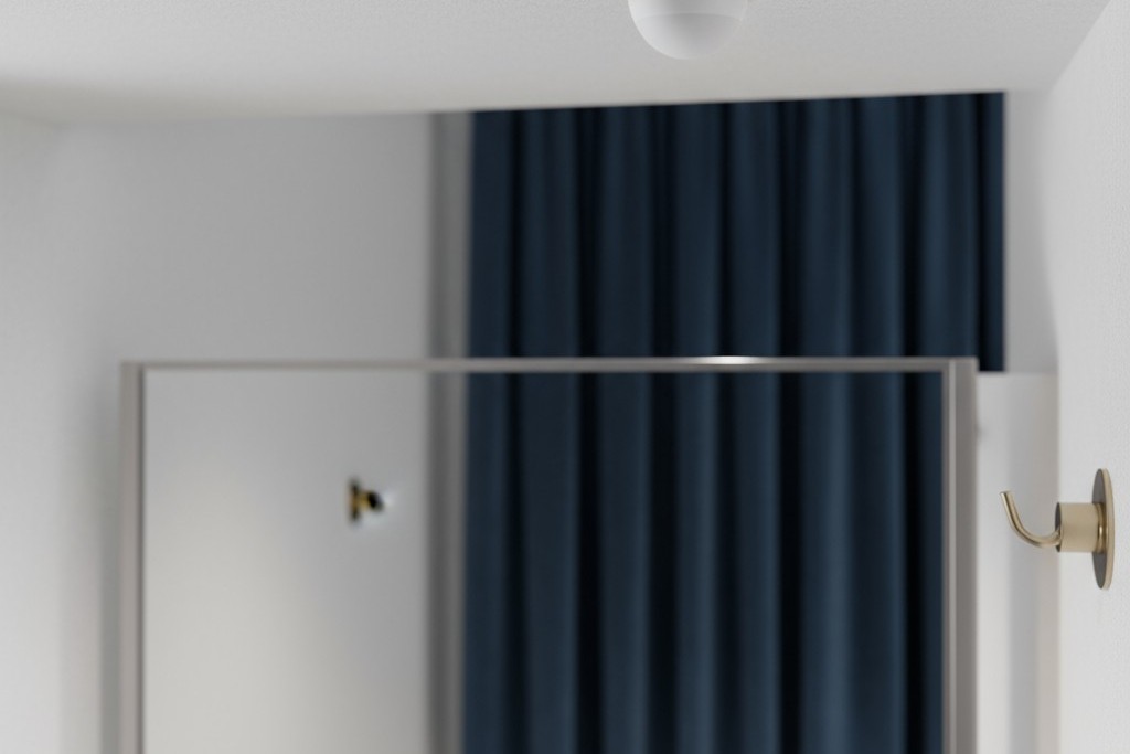 A small, unobtrusive motion sensor mounted in the corner of a stylish fitting room ceiling.