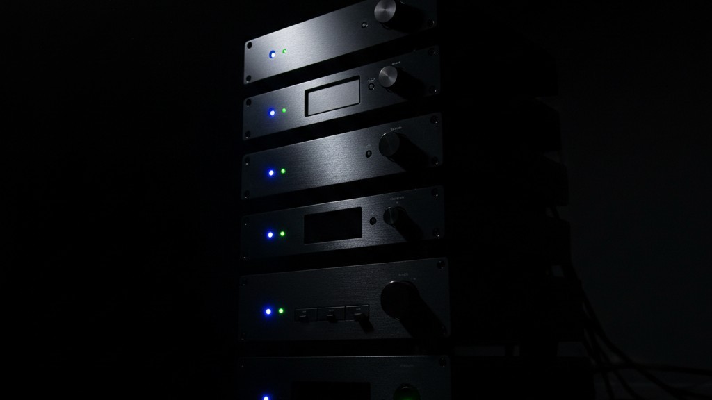 Distracting AV equipment LEDs A stack of home theater equipment in the dark with bright blue and green status lights glowing.