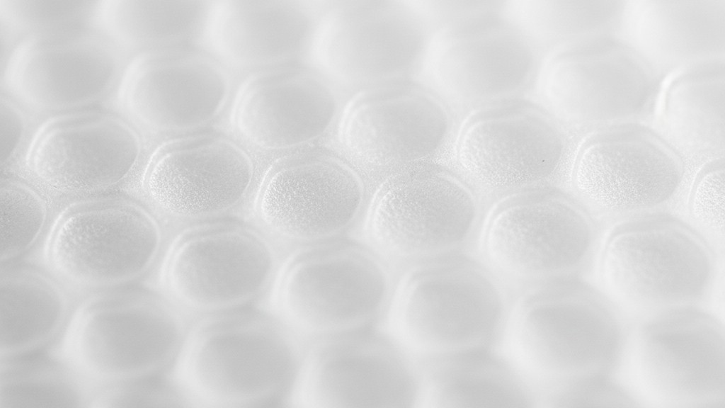 Fresnel lens macro texture An extreme close-up of a white plastic Fresnel lens showing its geometric, faceted surface texture.